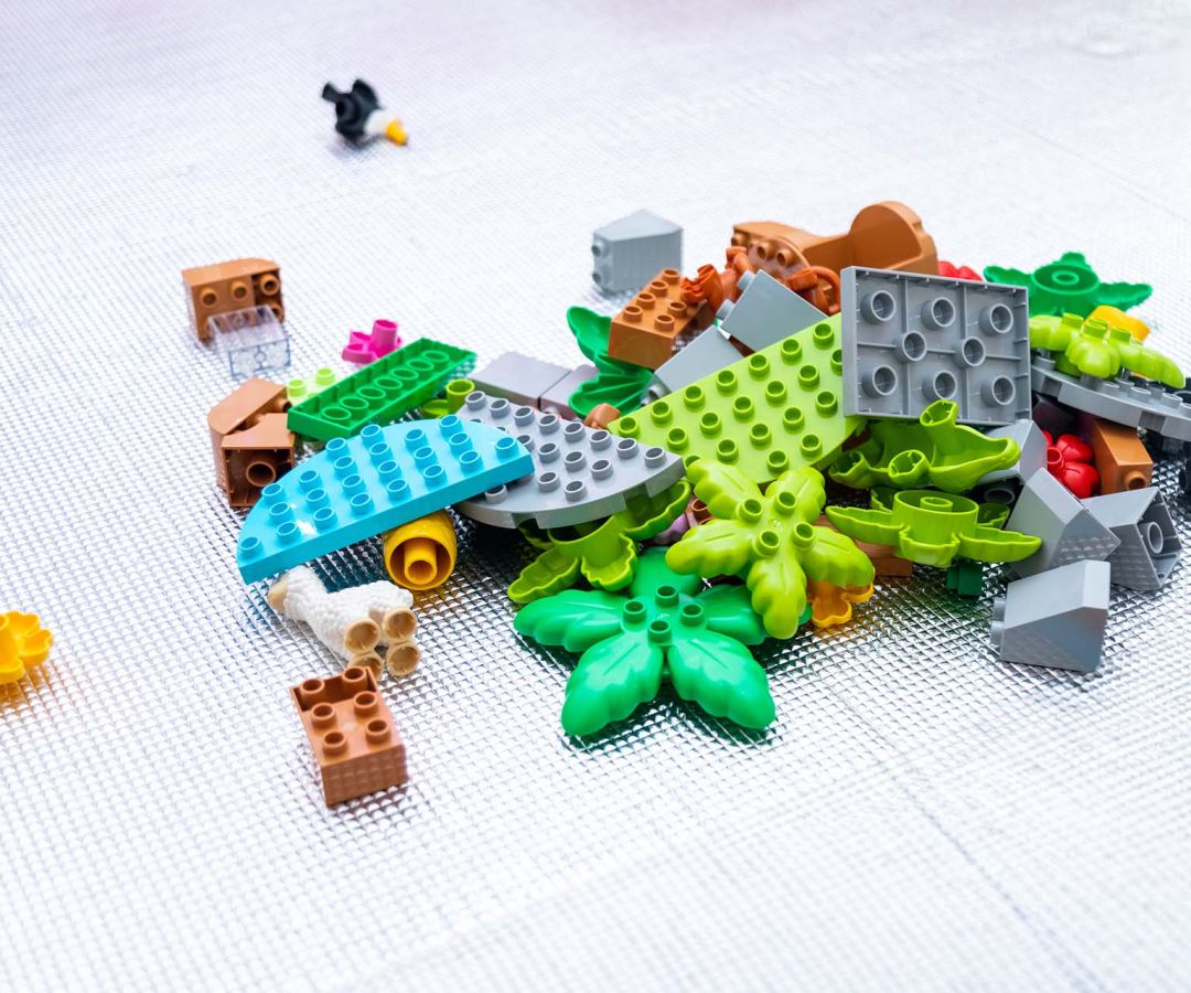 Assorted colorful LEGO blocks of different shapes piled together, representing problem solving and teamwork.